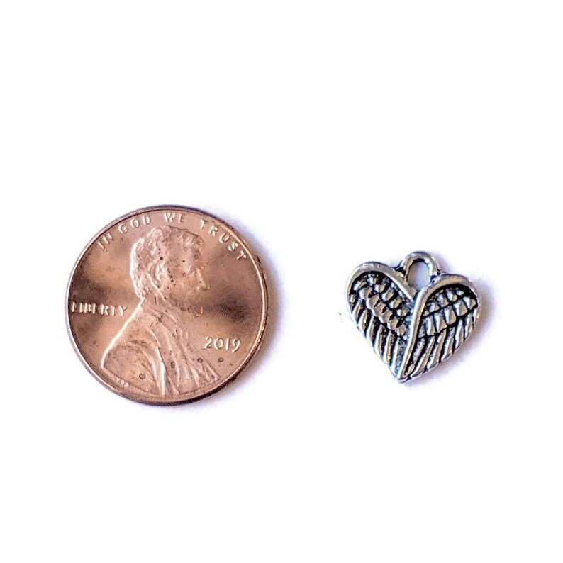 Tiny Silver Winged Heart Charm - - LadybugfeetDesigns -