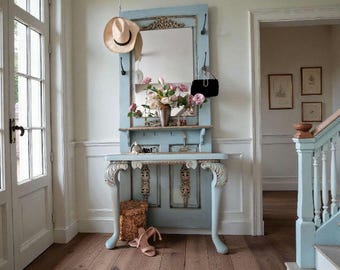 May include: A light blue entryway console with a mirror, shelf, and hooks. A straw hat and black purse hang from the hooks. A vase of flowers sits on the shelf, and a pair of shoes rests on the floor. The console has ornate detailing.