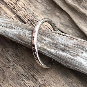 May include: A hammered silver ring with a textured finish.