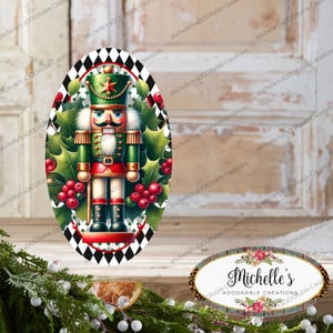 May include: An oval Christmas ornament featuring a detailed illustration of a nutcracker soldier. The ornament has a green and red color scheme, with holly and berries surrounding the nutcracker. The border is a black and white diamond pattern.