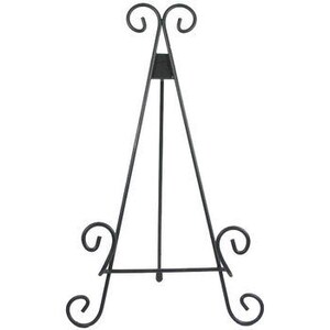 May include: Black metal easel stand with a decorative scroll design. The easel is designed to hold artwork, photos, or other items.