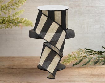 May include: Black and natural burlap striped ribbon with a wired edge. The ribbon is displayed on a spool.