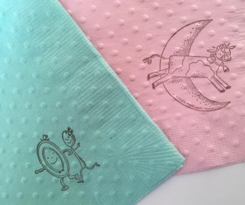 Mint and pink napkins with polka dots with nursery rhyme image stamped onto them. The images show the dish ran away with the spoon and the cow jumped over the moon.