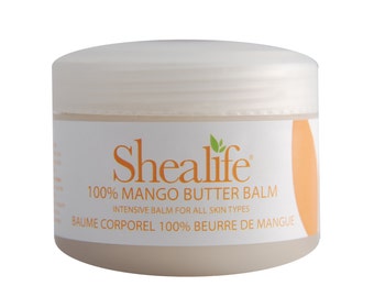 May include: A white jar with a white lid containing a light brown balm. The jar has a label with the text "Shealife 100% Mango Butter Balm Intensive Balm for All Skin Types Baume Corporel 100% Beurre de Mangue".