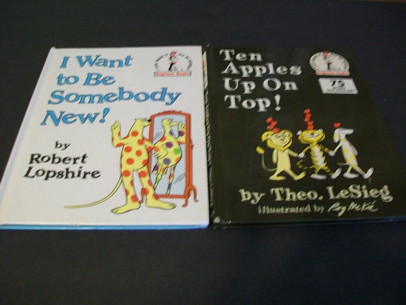 May include: Two children's books, one titled "I Want to Be Somebody New!" by Robert Lopshire and the other titled "Ten Apples Up On Top!" by Theo. LeSieg, illustrated by Roy McKie.