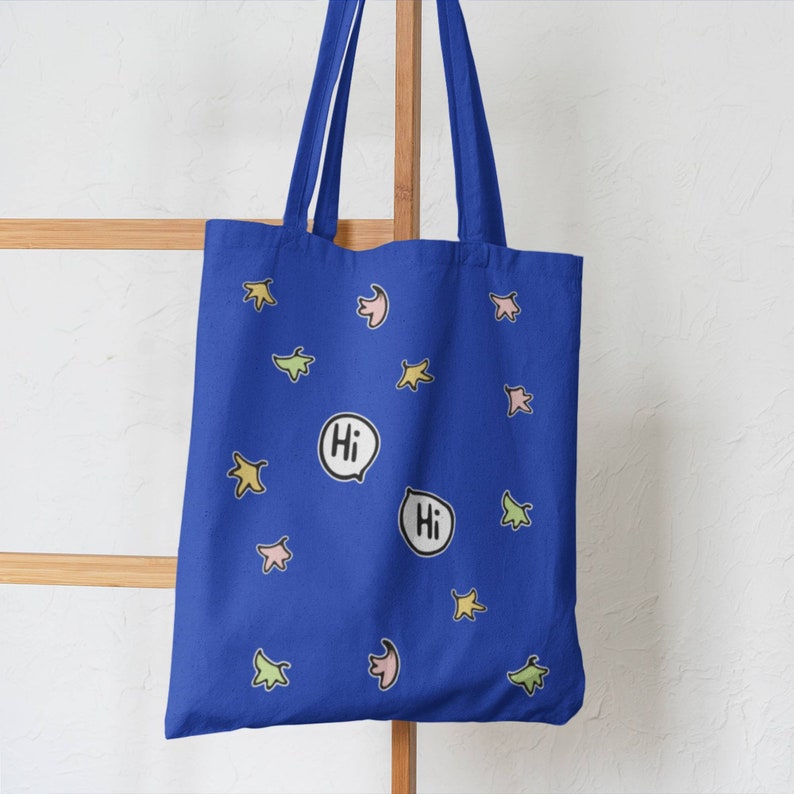 Heartstopper Leaves Tote Bag in Royal blue with FREE Vinyl Stickers. Heartstopper leaves printed on both sides of the bag along with two Hi quotes from the show.