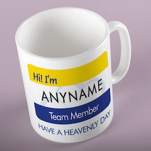 May include: White ceramic mug with a yellow and blue name tag that says "Hi! I'm ANYNAME Team Member Have a Heavenly Day".