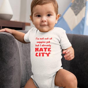 Manchester United Baby Gift. Smiling Baby Boy Hate City Baby Grow.
