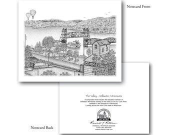 May include: A black and white illustration of a river town with a bridge, a boat, and hot air balloons in the sky. The text "COMM" is visible on a building in the foreground. The text "The Valley - Stillwater, Minnesota" is visible at the bottom of the image.