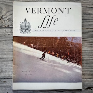 May include: Vintage "Vermont Life" magazine cover featuring a skier on a snowy slope. The magazine title is in large, bold letters, with the subtitle "The Vermont State Magazine." The cover is dated "Winter 1946."
