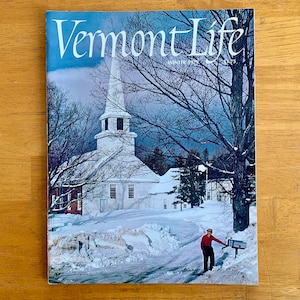 May include: A vintage magazine cover featuring a white church with a steeple in a snowy winter scene. The magazine is called "Vermont Life" and the cover text says "Winter 1975".