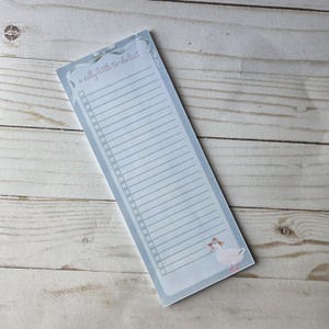 May include: A light blue to-do list notepad with a whimsical design. The notepad features a border with the text "a silly little to-do list" and a cartoon goose wearing a hat. The notepad has a lined section for writing and check boxes.