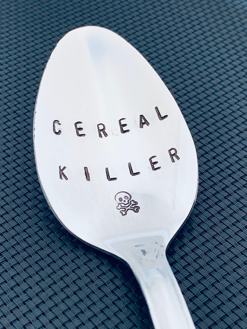 May include: A silver spoon with the words "Cereal Killer" engraved on it, along with a skull and crossbones.