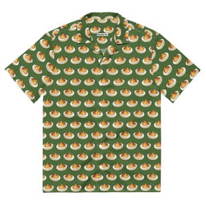 May include: Short-sleeved button-down shirt with a repeating pattern of deviled eggs on a green background. The shirt has a classic collar and a relaxed fit. The text "Fausome Art" is printed on the collar.
