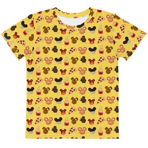 May include: Yellow t-shirt featuring a repeating pattern of cartoon food items, such as Mickey Mouse-shaped pretzels, ice cream bars, pizza slices, and ice cream cones. The shirt has a round neck and short sleeves.