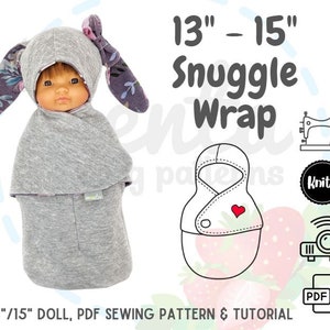 May include: A PDF sewing pattern and tutorial for a 13-15 inch doll snuggle wrap. The pattern includes a gray hooded wrap with a floral design and a red heart on the front. The pattern is available for download as a PDF file.