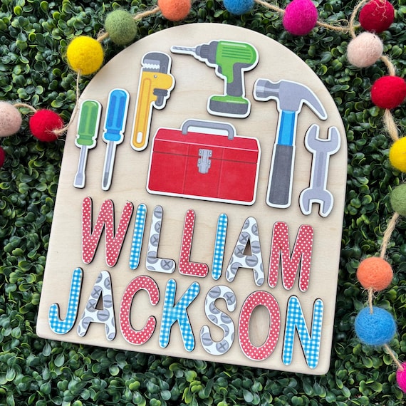 A construction-themed wooden name puzzle where the letters double as trucks and excavators — way more imaginative than a plain name puzzle.