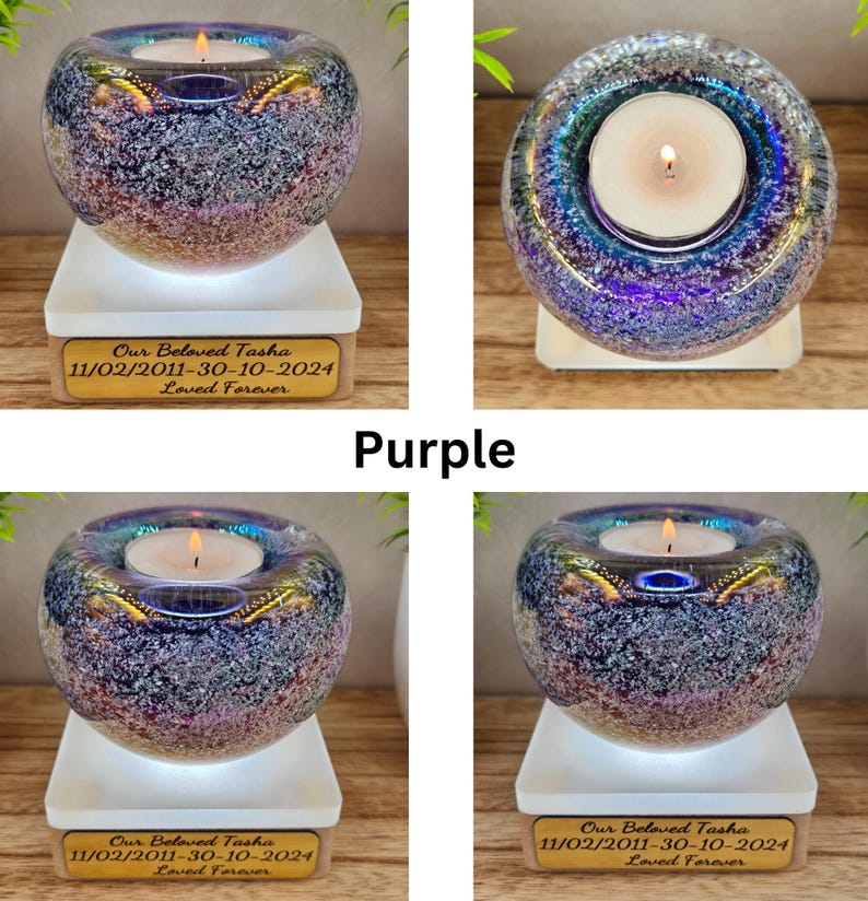 May include: A purple glass candle holder with a lit candle inside, resting on a white base. The candle holder has a speckled design and a gold-colored rim. A wooden plaque below reads "Our Beloved Tasha 11/02/2011-30-10-2024 Loved Forever."