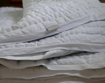 White on white appliquéd pure cotton hand quilted throw.