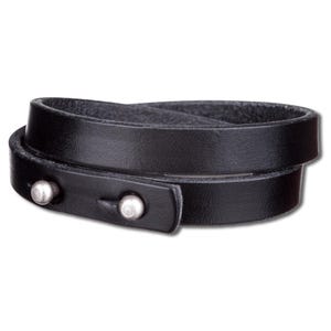 Può includere: Un braccialetto in pelle nera con due accenti in metallo argentato. Il braccialetto è avvolto due volte attorno al polso.