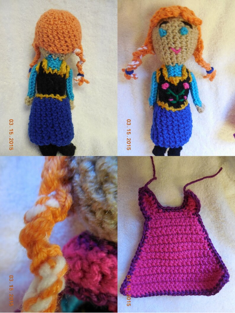 May include: A crocheted doll with long orange hair, wearing a blue dress with a black vest and a floral design. The doll is standing on a white surface.