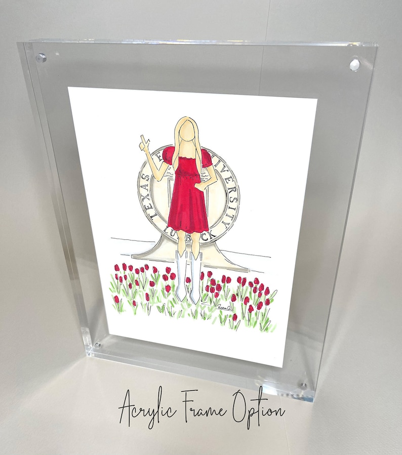 May include: A framed illustration of a woman in a red dress standing in front of the Texas Tech University seal. The woman is holding up two fingers in a peace sign. The seal is surrounded by red tulips.