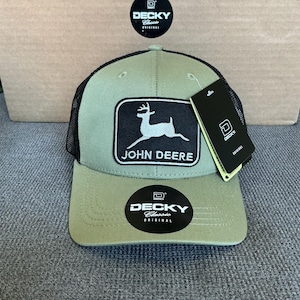 May include: A green and black trucker hat with the John Deere logo patch. The hat features a mesh back and a curved brim. The hat has the "DECKY Classic Original" logo on the front and a tag.