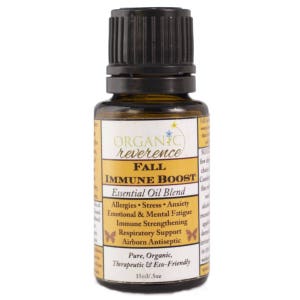 May include: A brown glass bottle with a black cap, labeled "ORGANIC reverence FALL IMMUNE BOOST Essential Oil Blend". The label also lists the benefits of the oil blend, including allergies, stress, anxiety, emotional and mental fatigue, immune strengthening, respiratory support, and airborne antiseptic. The bottle is 15ml/.5oz and is labeled as pure, organic, therapeutic, and eco-friendly.