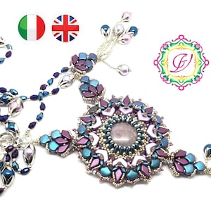 May include: A multi-strand necklace with a large, intricate pendant featuring a purple and blue gemstone surrounded by silver and white beads. The pendant is attached to a silver chain with a silver clasp. The necklace is made of various shades of purple, blue, and silver beads.