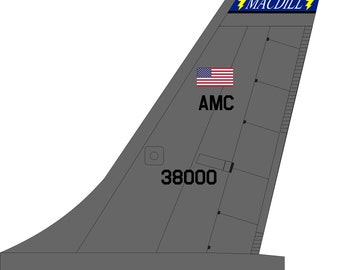 May include: A gray aircraft tail with the text "MACDILL" in yellow lightning bolts, "AMC" in black, and "38000" in black. The tail also features a small American flag.