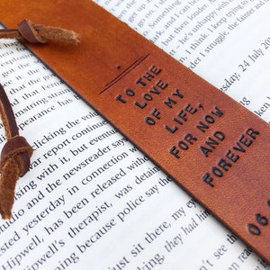May include: A brown leather bookmark with the text "To the love of my life, for now and forever" and the date "06.10.2016".
