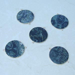May include: Five round, silver-toned, pendant charms with a dark blue and green marbled design.
