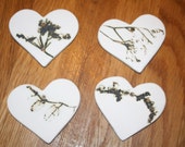 Porcelain hearts with plant impressions. Holed for hanging if required.