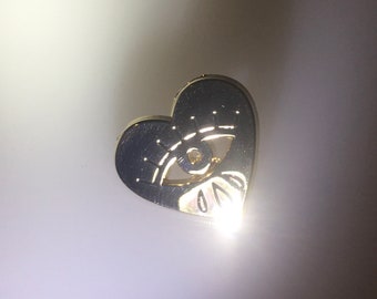 Gold crying heart eye pin