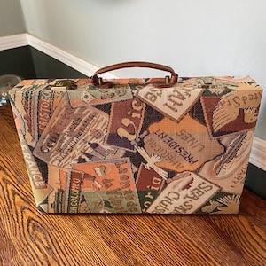 May include: A handmade wooden sign with the text "Welcome to our home" in a handwritten style. The sign is painted white with black lettering and a distressed finish, suitable for indoor or outdoor use.