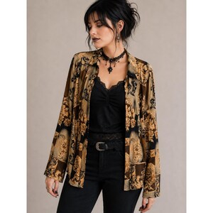May include: A long-sleeved button-down shirt featuring a tan and black floral pattern, worn over a black lace-trimmed camisole. The outfit includes black jeans with a silver-toned belt buckle and a black lace choker necklace with a central pendant.