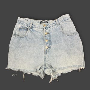 May include: Light blue denim shorts with a button-up fly and frayed edges. The shorts have front and back pockets and a high waist. The denim has a faded, acid-wash appearance.