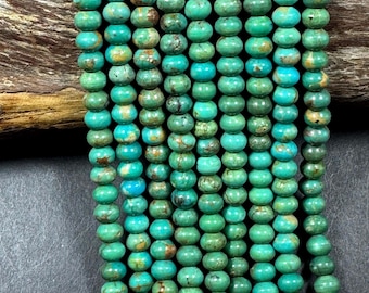 May include: Strands of turquoise beads in varying shades of green and blue. The beads are round and have a slightly irregular shape, giving them a natural, organic look. The beads are strung together, ready for jewelry making.