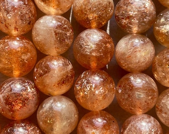 AAA Natural Fire sunstone bead. 6mm,8mm,10mm round smooth Gorgeous natural peach orange color with gold flash color. Stunning looking bead!