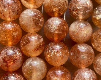 AAA Natural Fire sunstone bead. 6mm,8mm,10mm round smooth Gorgeous natural peach orange color with gold flash color. Stunning looking bead!