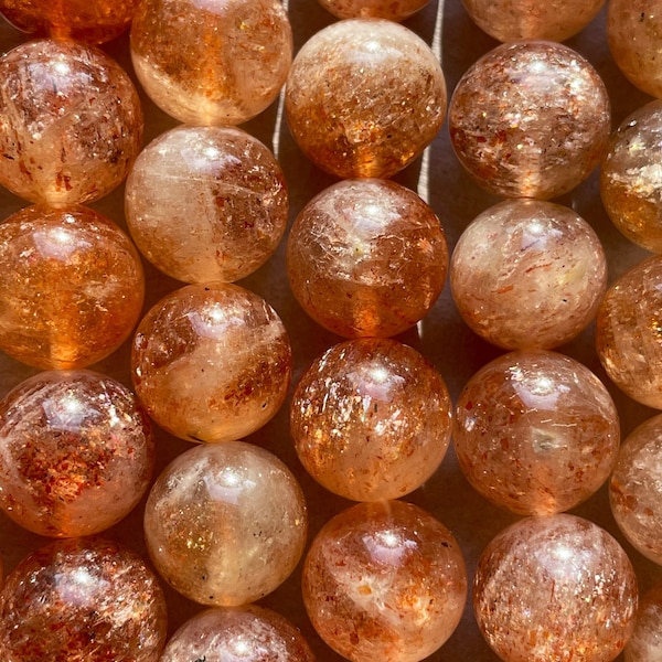 AAA Natural Fire sunstone bead. 6mm,8mm,10mm round smooth Gorgeous natural peach orange color with gold flash color. Stunning looking bead!