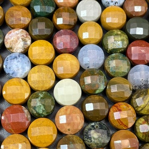 May include: A collection of round, polished stones with various patterns and colors, including brown, yellow, green, red, and white. The stones have a faceted, geometric design.