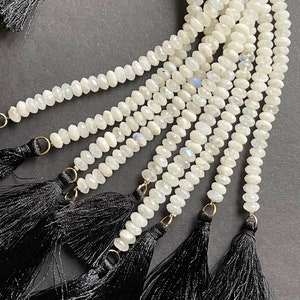 AA natural moonstone bead. Faceted 4x6mm Rondelle Shape bead. Beautiful natural white moonstone with black tassels. unique looking  bead.
