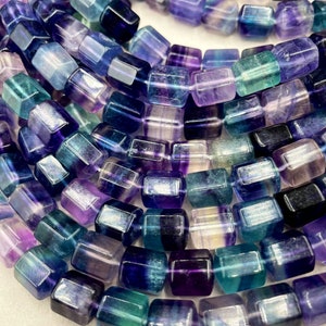 AAA Natural fluorite stone bead . Faceted 8x10mm tuba shape . Beautiful natural purple green super clear. Real nice quality fluorite  15.5”