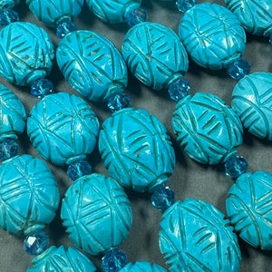hand carved turquoise gemstone bead . 35mm oval shape . excellent quality blue turquoise beads . full strand 15.5”