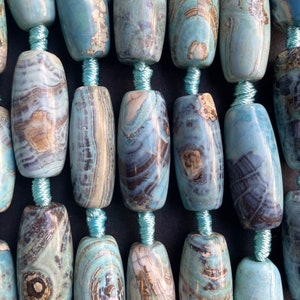 Beautiful natural dragon skin agate stone bead. 13x30mm barrel shape. Beautiful sea blue color with brown dots gemstone bead. 15.” Strand