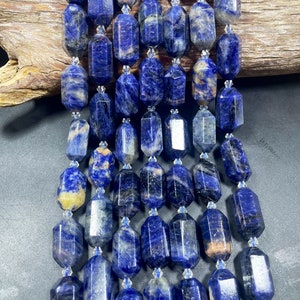 Natural blue sodalite gemstone bead. Faceted 14x28mm barrel shape. Natural blue color gemstone bead.