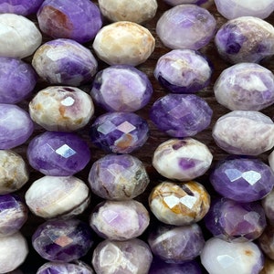 AAA natural flower amethyst gemstone bead. Faceted 5x8mm Roundell shape bead. Gorgeous natural purple color amethyst gemstone bead.
