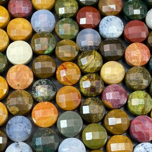 May include: A collection of round, faceted gemstone cabochons in various colors and patterns, including green, brown, yellow, red, and white.