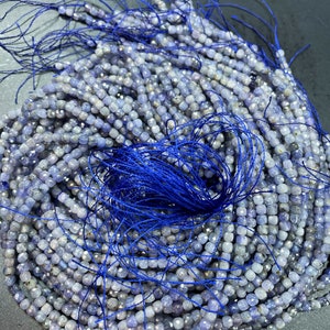 AAA natural tanzanite gemstone bead. Faceted 4mm cube shape bead. Gorgeous natural purple blue color. High quality tanzanite gemstone bead.